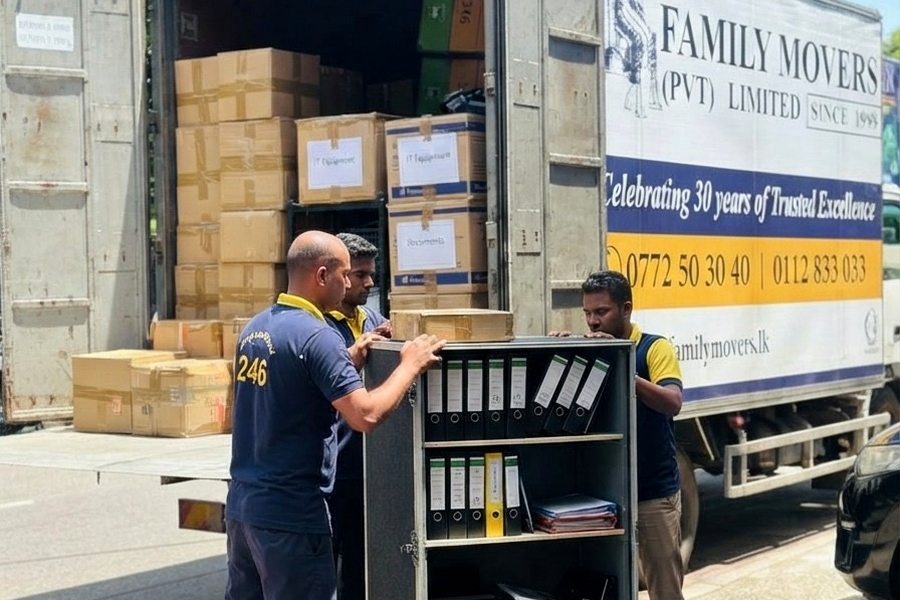 Office and IT equipment being loaded into a Family Movers truck